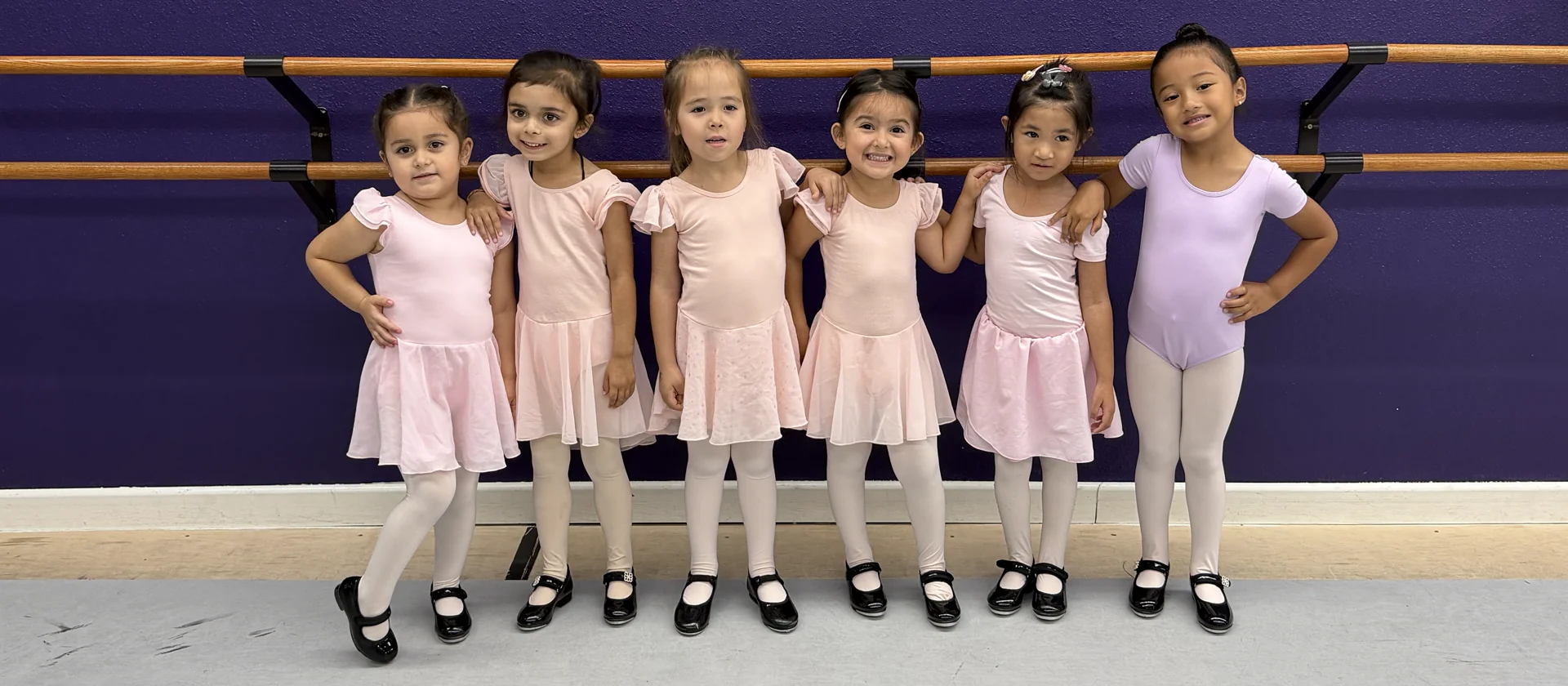 Serendipity dancers in pink and lavender class dancewear and tap shoes at the studio barre