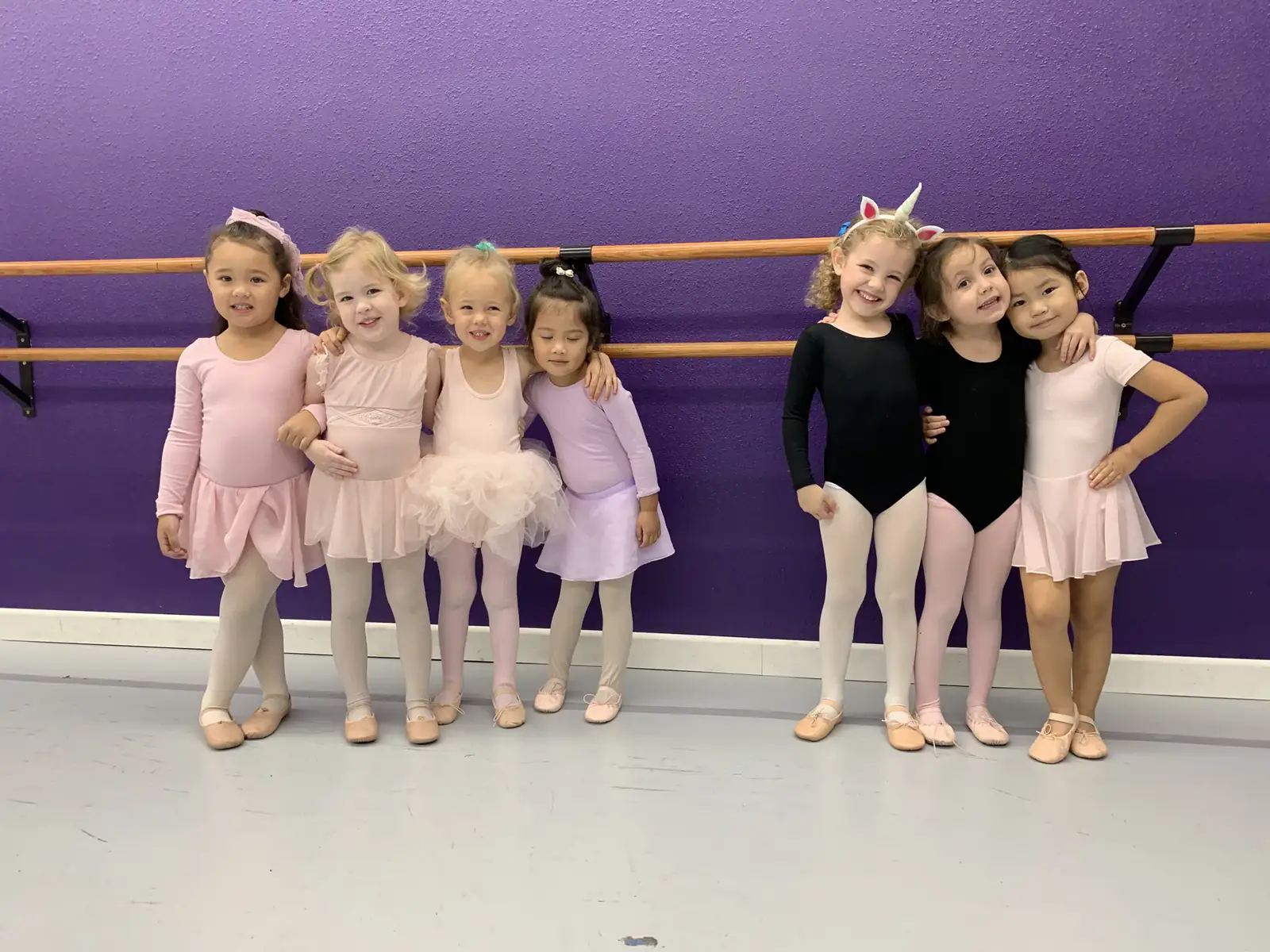 Young Serendipity dancers together at the studio barre